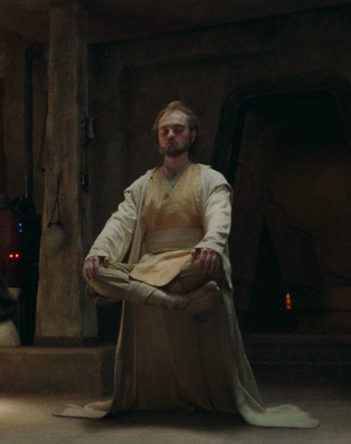 Screenshot from The Acolyte showing Jedi Master Torbin cross-legged and floating 1 meter off the ground, eyes closed in silent meditation.
