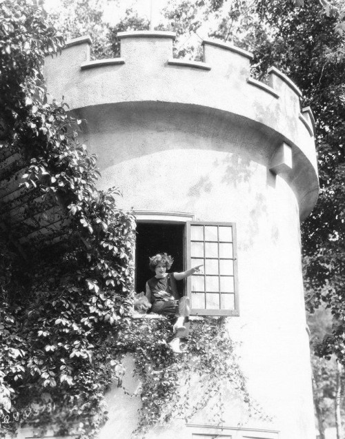 Clara Bow sits on her window sill at home. | 1926