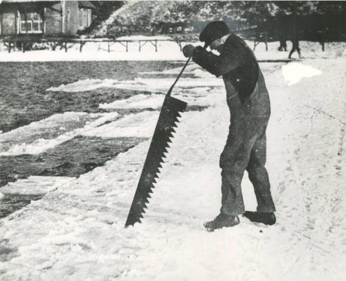 Man cutting ice with large saw embedded in river ice, pre 1960.via: Historic Photo Collection, F.P. 