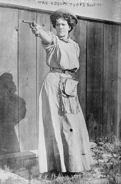 Mrs. Adolph Topperwain with gun, ca. 1910-1915.
