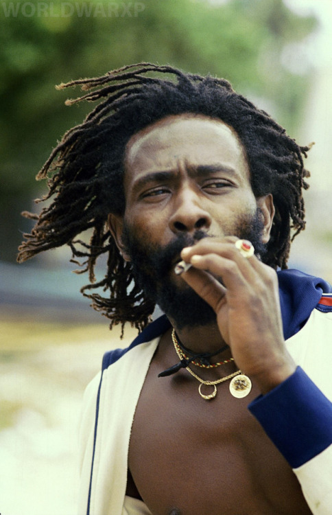  Burning Spear smokes a joint while walking the shoreline, 1979.Photographer:Dave HendleyLocation 