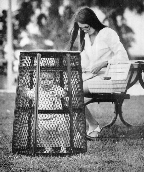 blueandbluer: through-a-historic-lens: Mom Uses A Trash Can To Contain Her Baby While She Crochets I