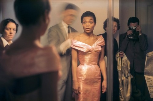 themaninthegreenshirt:Eartha Kitt looks at her reflection in a full-length mirror as Hubert de Given