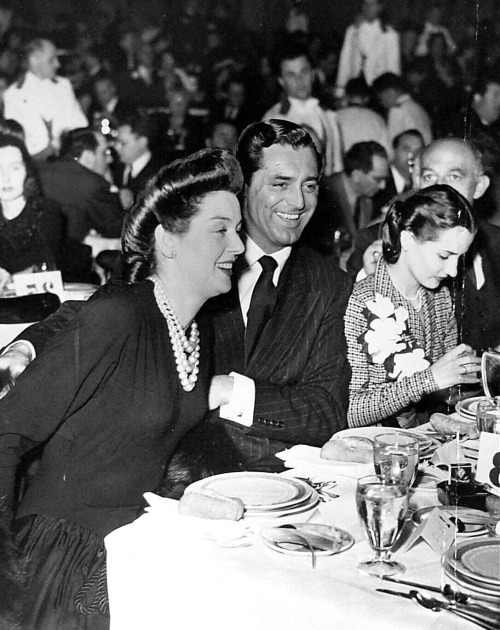 archiesleach:Cary Grant and good friend Rosalind Russell have fun at an event, 1942