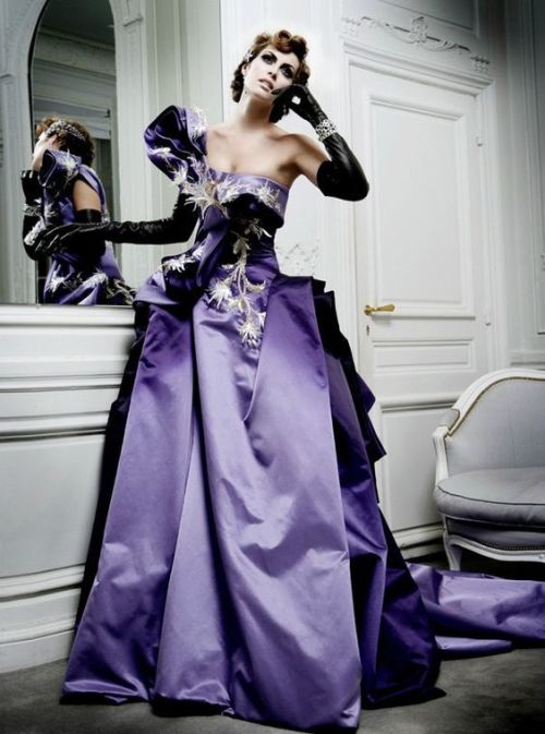 Purple satin fitted gowndrapes softly to the groundfrom corset top over hips and thighsI do hope it’