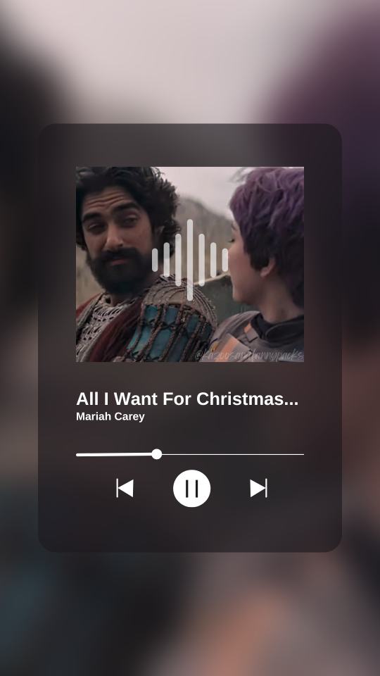 A fake screenshot of a song playing on a music player app. This one shows Ezra smiling at Sabine as the album cover, with the playing track being All I Want For Christmas Is You by Mariah Carey.