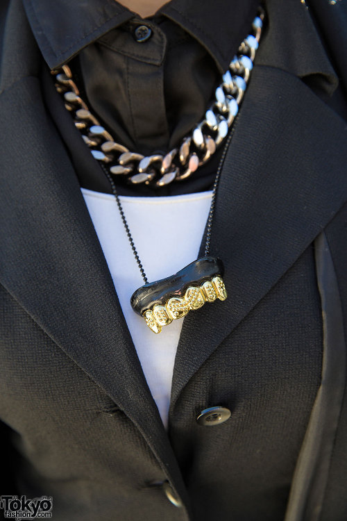 20-year-old Shii on the street in Harajuku wearing a resale layered black and white outfit with a wi