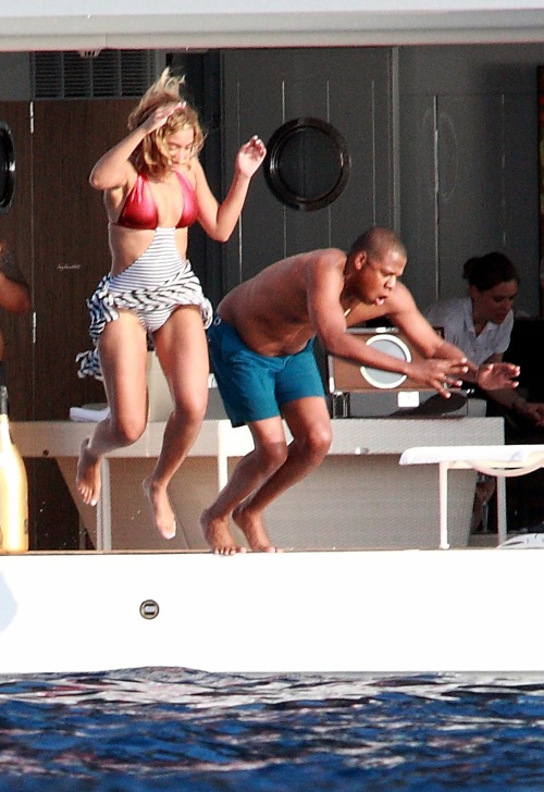 beyhive1992:   A recent photo from their New Year’s vacation in St. Barths shows Beyoncé jumping into the water off the bridge of a three-story, 14-foot yacht while Jay captures the moment with a video camera. It was a long way down. “Yeah it was,”