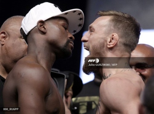  Boxer Floyd Mayweather Jr. (L) and MMA figher Connor Mcgregor pose during their weigh- in on August