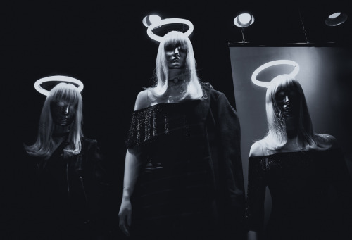 Unholy TrinityThree halo adorned mannequins in a fashion store display window. City of London.