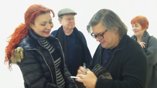 Joseph Nechvatal signing a copy of his poetry book Destroyer of Naivetés.