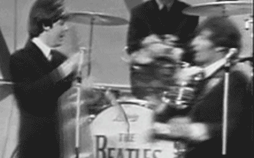 annalikesthings:  John Lennon presents Paul McCartney with “gag flowers” after his performance of “Yesterday”. 