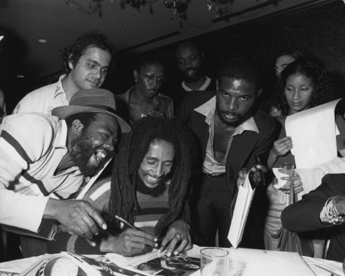 Bob Marley signing autographs at a release event for 1979’s “Survival” album in Wa