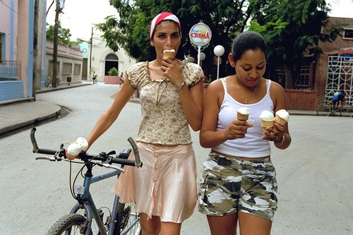 cubaypuertoricoson:Cuban girls enjoying ice cream in Cuba after a long bike ride.