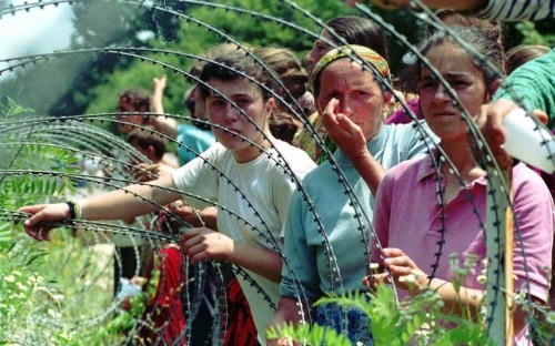 July 1995: A group of Bosnian Muslims, refugees from Srebrenica, walk to be transported from the eas