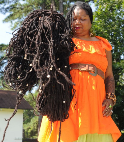 babybints:  flyandfamousblackgirls:  Asha Mandela is the Guiness Record’s “World’s Longest Locs”. She is often referred to as the “9th Wonder of The World”. Asha started growing her locs more than 25 years ago. Her locs are longer than 25