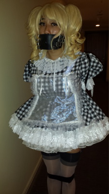 sissybimbodolly:  What happened…? I woke up, suddenly fully clad in the most humiliating prissy sissy gingham dress ever, with thick masses of petticoats putting my matching panties on display. I was blonded, corseted, bound with an armbinder and tape,