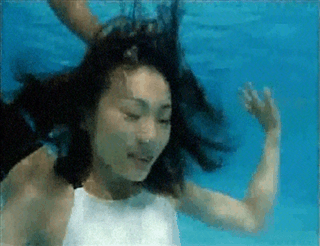 Women Blowing Bubbles Underwater