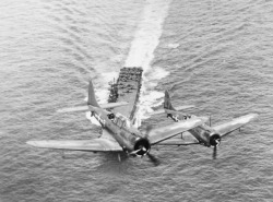 usaac-official:  SBD-5s of VB-6 in flight over USS Enterprise (CV-6), 12 November 1943