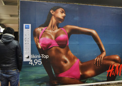 Street artist defaces bikini advertisement