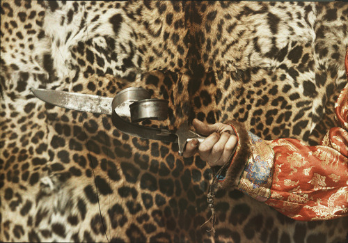 A Tibetan spiritual figure holds a Mongolian blade after twisting it with his seemingly superhuman s