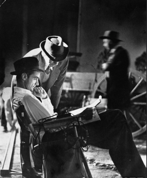 Howard Hughes studying a script on the set of his 1943 Western, THE OUTLAW. Photo by Bob Landy for L