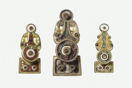 artofthedarkages: Three luxuriously decorated disc-on-bow brooches. Cast out of bronze, with gilding