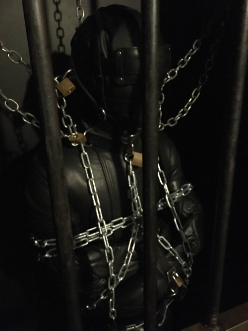 seabondagesadist:  Straitjacket and cell storage. The boy wanted to make me happy. Nothing makes me happier than a boy in heavy bondage, leathered and chained up in the cell for awhile… 😈😈😈 