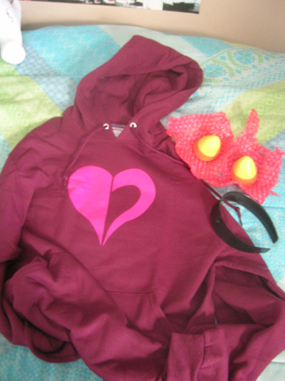 in other news look what i got todaaayyyi finally got a heart hoodie and nepeta horns! i just got to screw the horns onto the headband later i also got the sweater i bought for my human!karkat cosplay but i’ll show that later c: 