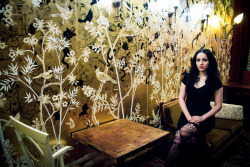 mollycrabapple:   Me in Kitty’s Canteen, the new restaurant I spent all of February defacing with sharpies, late into the night.  Wallpaper is DeGourny, a thousand bucks a yard.  I drew everywhere. Photo by Najva Sol 