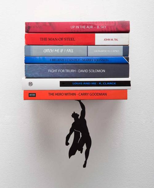 jasab:  A magnet is employed to suspend the superhero in the air, giving the impression of him ‘saving’ the books from an imminent fall, and it costs just ษ (plus additional shipping fee) on designboom.com/shop. I want it!  