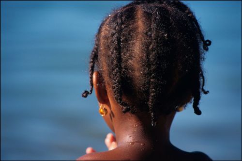 africansouljah:Ian BerryTRINIDAD. Nr Port of Spain. Young girl with Trinidadian hairstyle on the bea