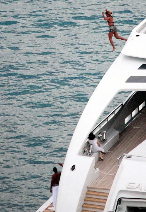 beyhive1992:   A recent photo from their New Year’s vacation in St. Barths shows Beyoncé jumping into the water off the bridge of a three-story, 14-foot yacht while Jay captures the moment with a video camera. It was a long way down. “Yeah it was,”