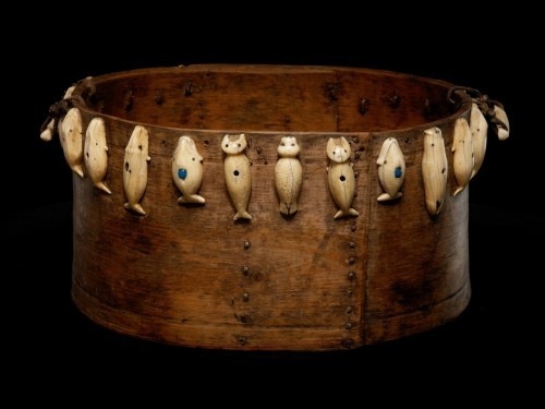 This Inupiaq feast bowl was collected in 1934 in Wales, Alaska. The ivory carvings on this bowl repr