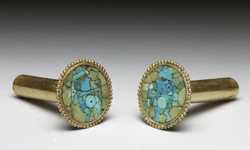 Turquoise and precious stones were organized in the mosaic you see, mounted on hammered sheets of go