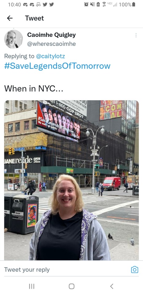 picture of a tweet of blonde person standing across from the save legends of tomorrow billboard in New York