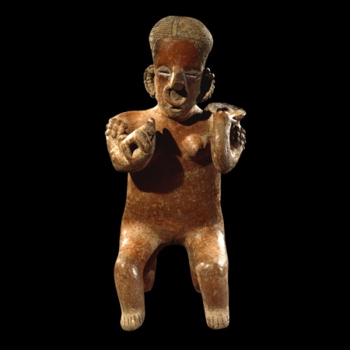 Pottery figurine of a woman holding a dog From Nayarit, West Mexico 300 BC - AD 300 Large, hollow ce