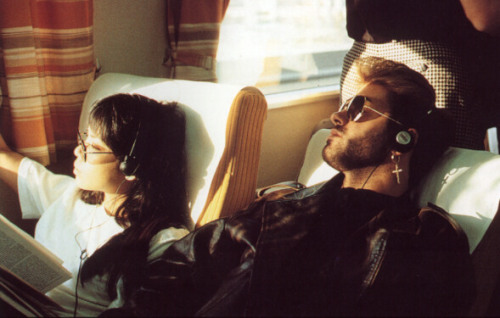 George Michael with girlfriend Kathy Yeung, on a train listening to a walkman, Japan, March 1988