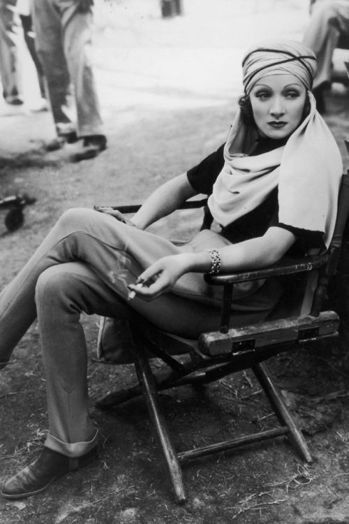 Marlene Dietrich relaxing with a cigarette (and a turban) on the set of The Garden of Allah, 1936