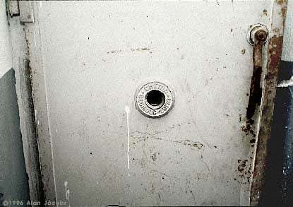 sixpenceee:  THE JUDAS OPENING A peephole in the door of a gas chamber in which people