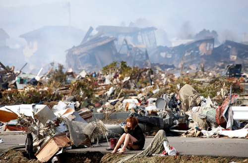 Photo by Asahi Shimbum   |   Natori, Japan   |   March 13, 2011A woman sits amidst wreckage caused b