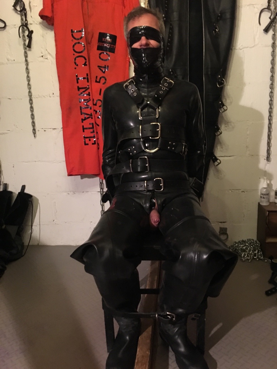 jamesbondagesx:  Rubber gimp strapped to chair, gagged, head mummified, gas masked