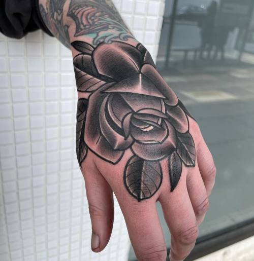 allthepiercingsandbodymods:Black rose hand tattoo by Mattwebbtattoo on Instagram.