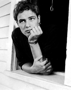 babeimgonnaleaveu:    Marlon Brando leans through the window of his parents home during a visit, Libertyville, Illinois, 1951.   