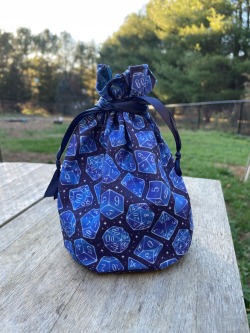 I made a dice bag from some cool custom fabric! It’s currently 1 of 1 from me, and can hold a crazy amount of dice, or like…. Anything you gotta hold on to. Formally Sew Cute Crafts and Art! working on rebranding by TheCraftyDruidXO