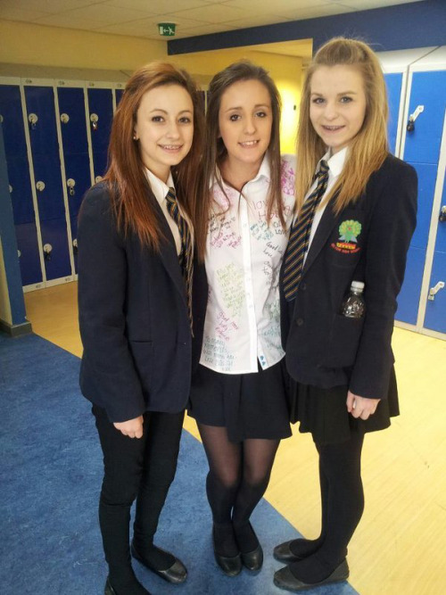 schooluniformfashions: Two fashionable girls stand with their pants wearing friend.