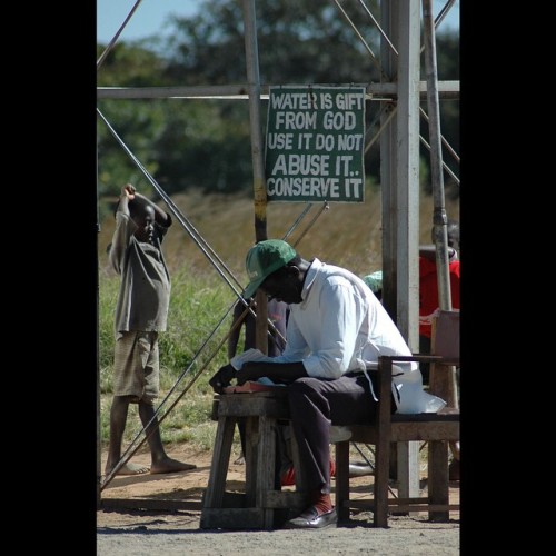 A Man Reads #verses From The #Bible As He #guards A Water Tank At The #crossroads Near #Serenje, #Zambia.