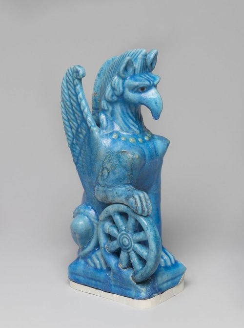 historyarchaeologyartefacts:Glazed faience figurine of Nemesis in the form of a female, winged griff