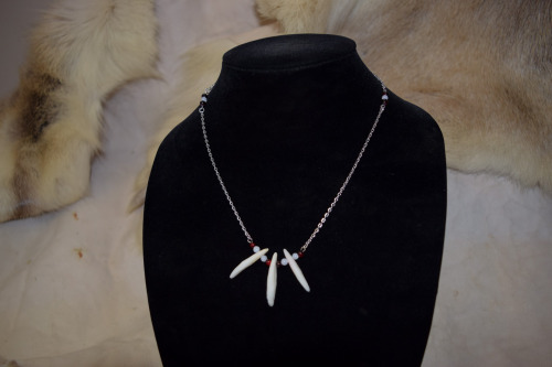 Multiple variations of coyote teeth necklaces, available with silver tone or black chain on each! Av