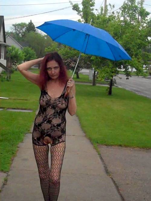 showoffmyslut: Posing in public on a rainy day wearing her new body-stocking (and a couple indoor s